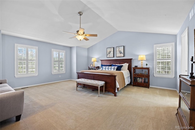 carpeted bedroom featuring lofted ceiling, baseboards, and ceiling fan