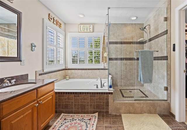 full bathroom with a shower stall, a bath, vanity, and tile patterned flooring