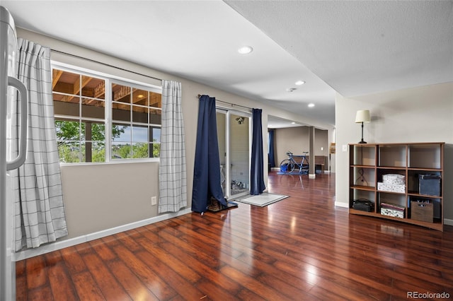 empty room featuring baseboards, wood finished floors, and recessed lighting