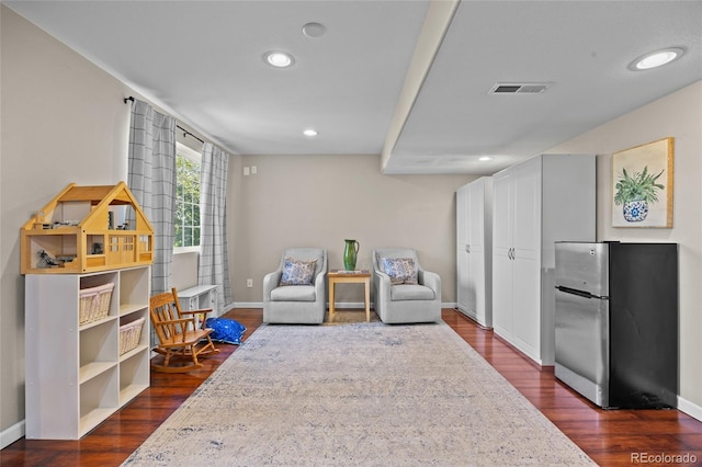 sitting room featuring baseboards, recessed lighting, and dark wood-style flooring