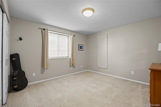 spare room with carpet and baseboards