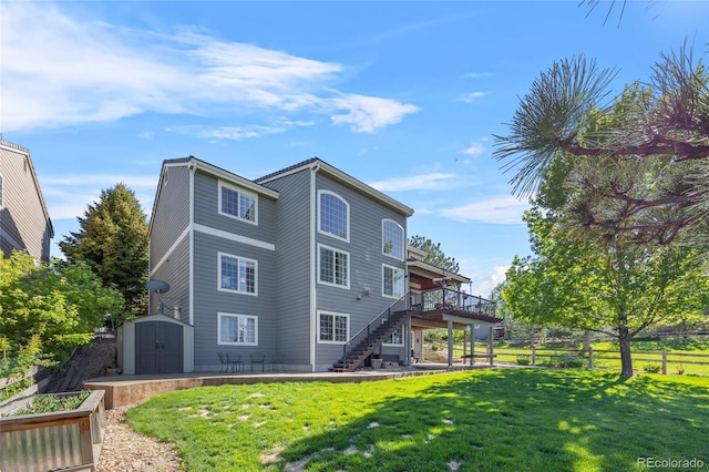 rear view of property featuring stairway, a shed, a wooden deck, a patio area, and an outdoor structure