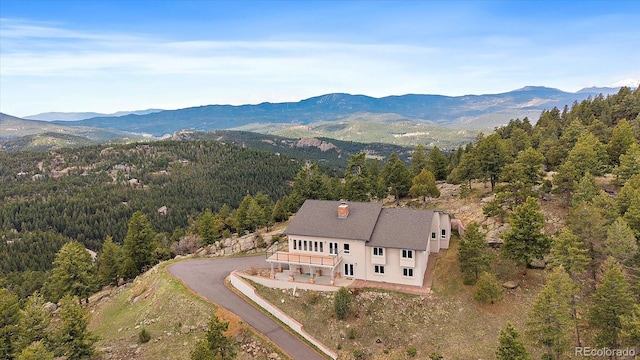 5197 Bear Mountain Dr, Evergreen, CO 80439 - birds eye view of property featuring a wooded view and a mountain view