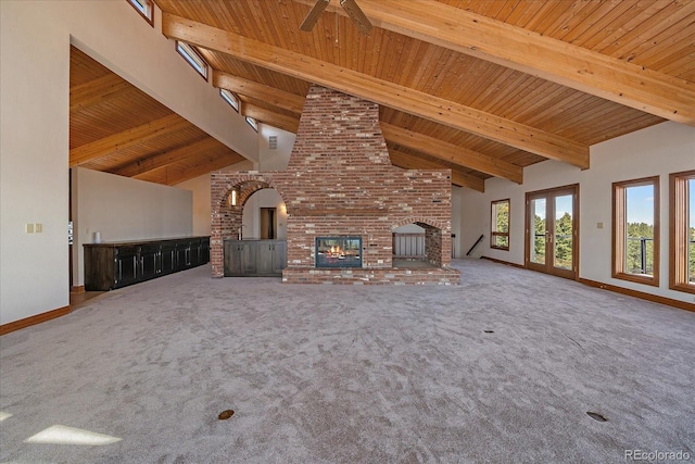 5197 Bear Mountain Dr, Evergreen, CO 80439 - unfurnished living room featuring baseboards, carpet flooring, wood ceiling, high vaulted ceiling, and a fireplace