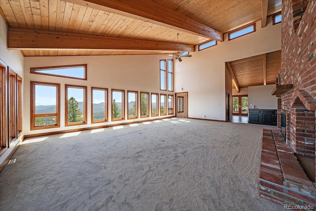 5197 Bear Mountain Dr, Evergreen, CO 80439 - unfurnished living room with carpet, wood ceiling, high vaulted ceiling, beam ceiling, and baseboards