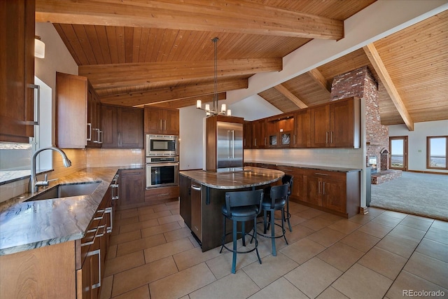5197 Bear Mountain Dr, Evergreen, CO 80439 - kitchen featuring built in appliances, a sink, vaulted ceiling with beams, and tasteful backsplash