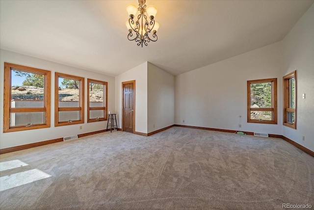 5197 Bear Mountain Dr, Evergreen, CO 80439 - carpeted spare room with an inviting chandelier, vaulted ceiling, baseboards, and visible vents