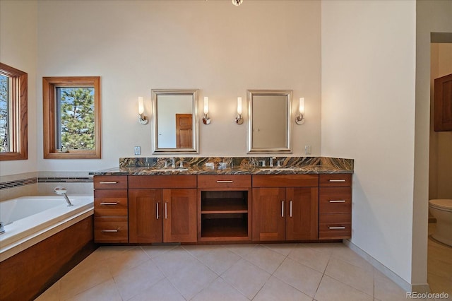5197 Bear Mountain Dr, Evergreen, CO 80439 - bathroom with double vanity, toilet, a sink, tile patterned flooring, and a towering ceiling