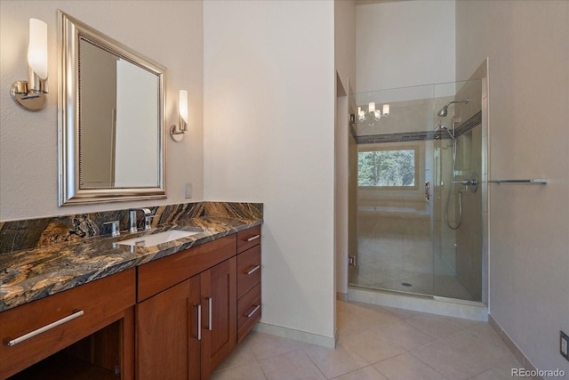 5197 Bear Mountain Dr, Evergreen, CO 80439 - full bath with a stall shower, vanity, baseboards, and tile patterned floors