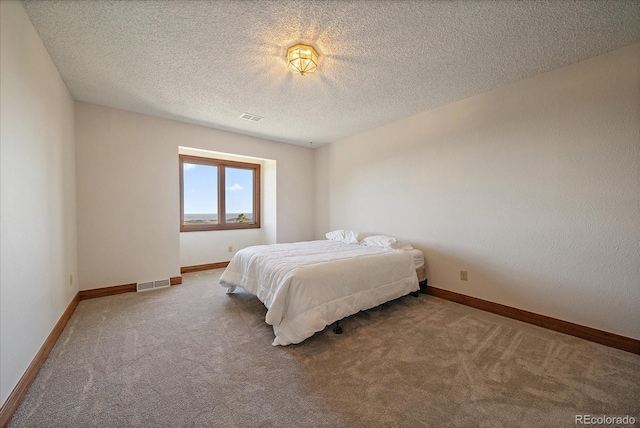 5197 Bear Mountain Dr, Evergreen, CO 80439 - carpeted bedroom with a textured ceiling, visible vents, and baseboards