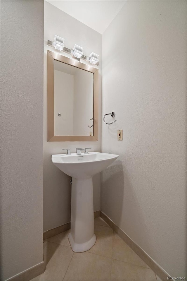 5197 Bear Mountain Dr, Evergreen, CO 80439 - bathroom with a sink, baseboards, and tile patterned floors