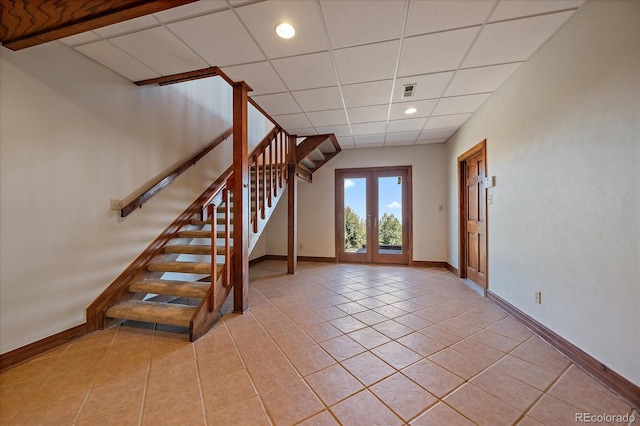 5197 Bear Mountain Dr, Evergreen, CO 80439 - interior space featuring a drop ceiling, french doors, baseboards, visible vents, and tile patterned flooring