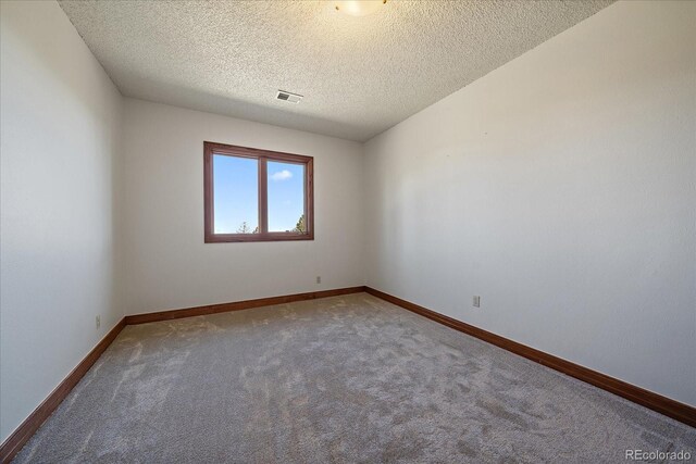 5197 Bear Mountain Dr, Evergreen, CO 80439 - empty room with a textured ceiling, carpet floors, baseboards, and visible vents