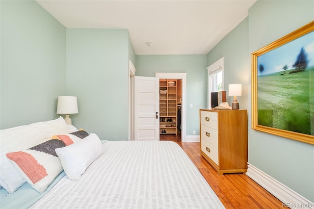 2228 N Race St, Denver, CO 80205 - bedroom with light wood-style floors, a spacious closet, and a closet
