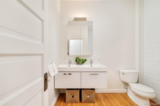 2228 N Race St, Denver, CO 80205 - bathroom with wood finished floors and double vanity
