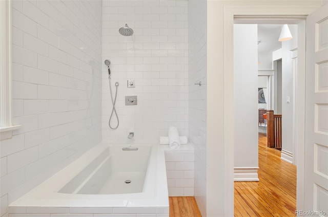 2228 N Race St, Denver, CO 80205 - bathroom featuring wood finished floors and bathtub / shower combination
