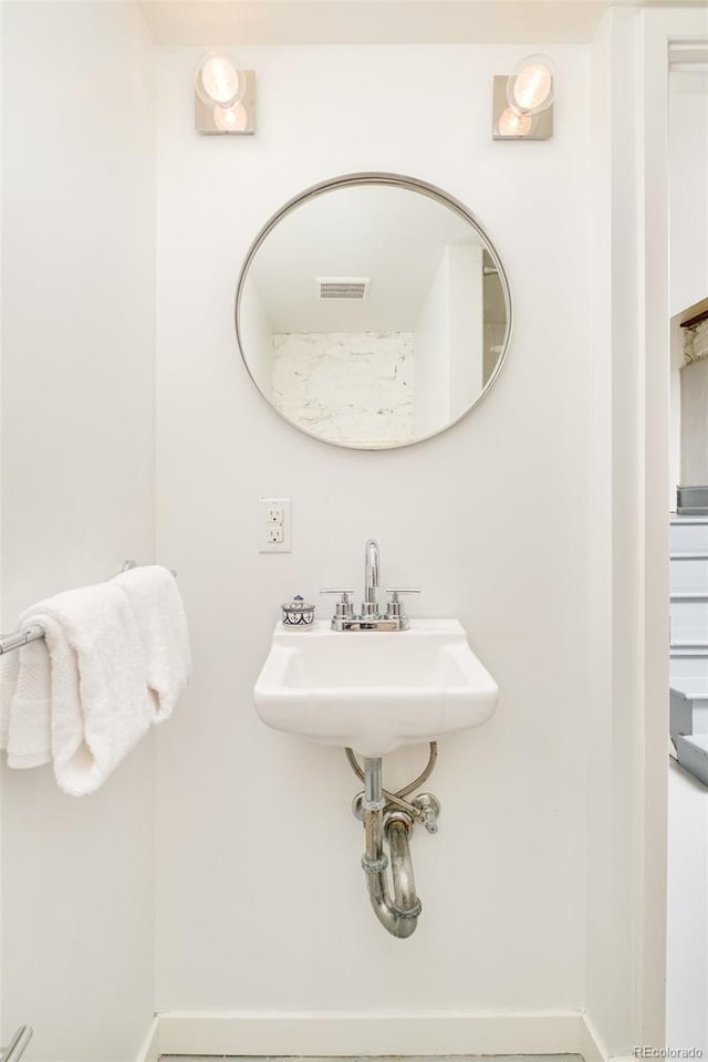 2228 N Race St, Denver, CO 80205 - bathroom with baseboards and a sink