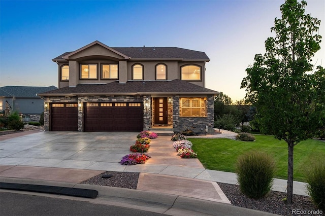 view of front of property featuring a yard and a garage