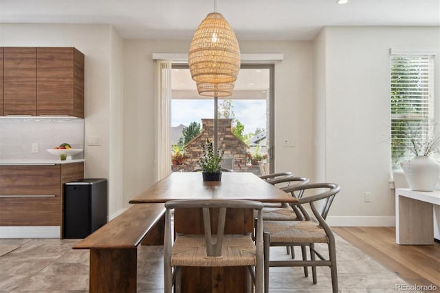 dining space with plenty of natural light and light wood-type flooring