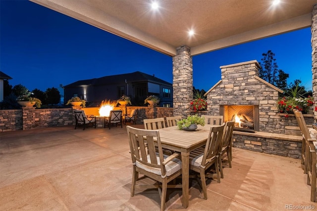 patio at night with an outdoor stone fireplace