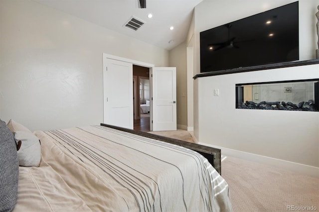 bedroom with lofted ceiling and carpet