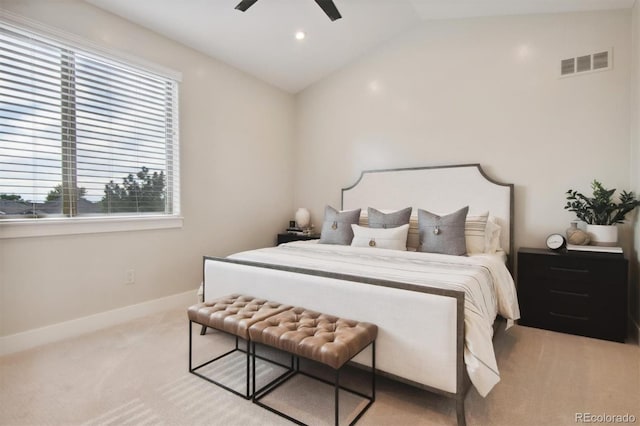 bedroom featuring vaulted ceiling, light colored carpet, and ceiling fan