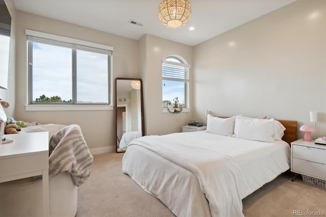 bedroom featuring light colored carpet