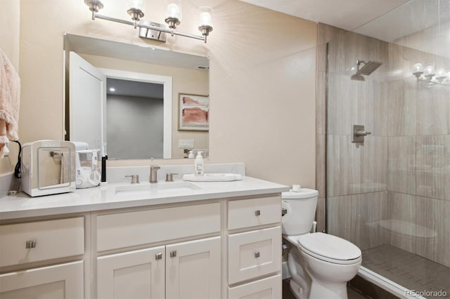 bathroom featuring walk in shower, vanity, and toilet