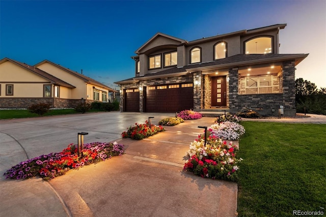 view of front of home featuring a garage and a lawn