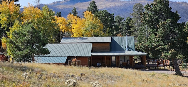 exterior space with a mountain view and metal roof