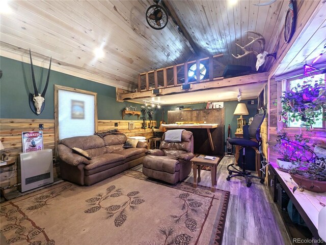 living area featuring wooden walls, wooden ceiling, a wainscoted wall, wood finished floors, and vaulted ceiling