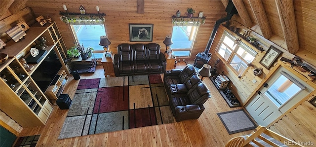 living room featuring log walls and wood finished floors