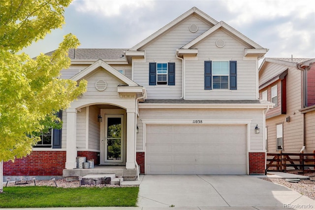 11038 Unity Ln, Commerce City, CO 80022 - view of front of home featuring brick siding, a garage, and driveway