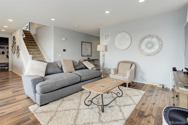 11038 Unity Ln, Commerce City, CO 80022 - living room featuring wood finished floors, stairs, and recessed lighting