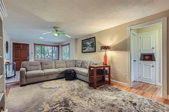 6260 W 45th Pl, Wheat Ridge, CO 80033 - living room featuring wood finished floors, ceiling fan, a textured wall, and baseboards