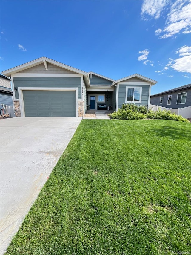 3892 Hackberry St, Wellington, CO 80549 - ranch-style home with a garage, driveway, a front yard, and stone siding