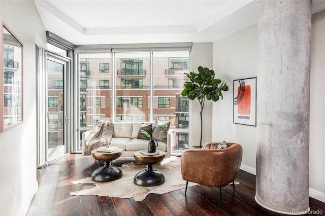 living area featuring baseboards and wood-type flooring