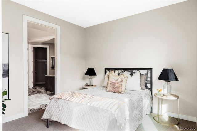 bedroom featuring baseboards and carpet