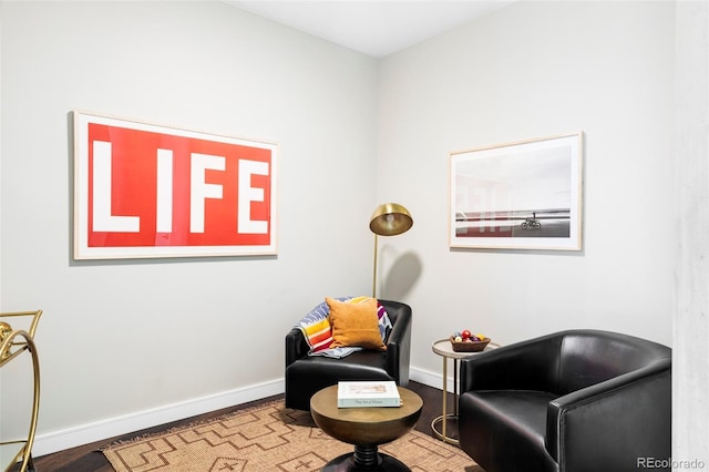 living area with wood finished floors and baseboards