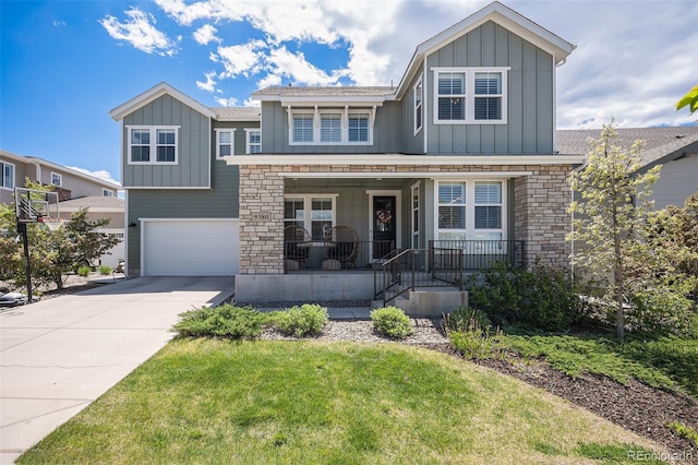 9380 Bear River St, Littleton, CO 80125 - view of front of property with board and batten siding, an attached garage, covered porch, driveway, and stone siding