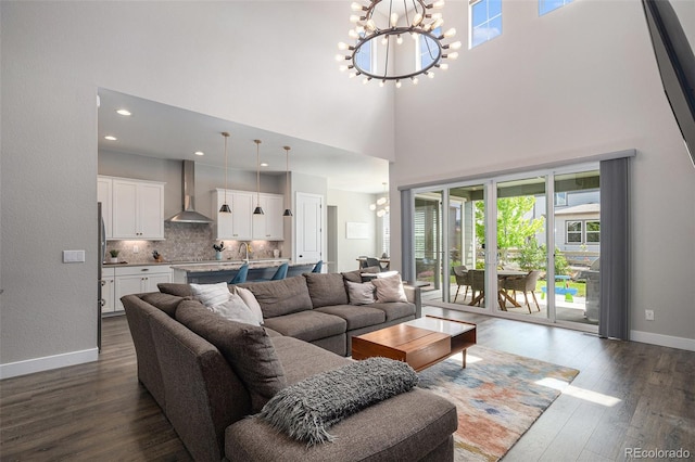 9380 Bear River St, Littleton, CO 80125 - living area with a chandelier, healthy amount of natural light, dark wood-style flooring, and a high ceiling