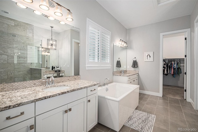 9380 Bear River St, Littleton, CO 80125 - full bath with a tile shower, two vanities, a freestanding bath, tile patterned floors, and baseboards