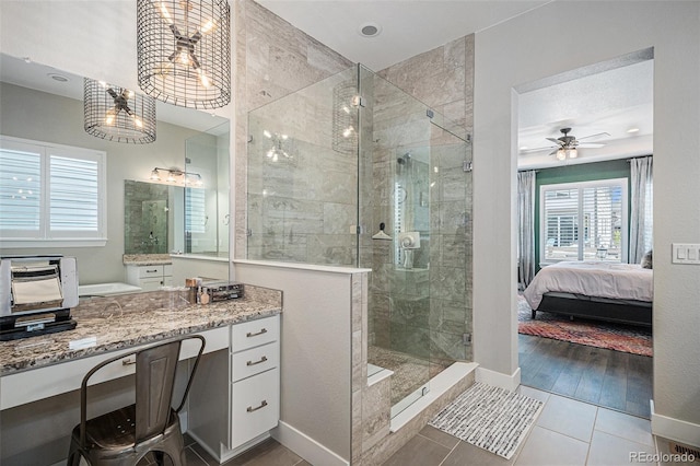 9380 Bear River St, Littleton, CO 80125 - ensuite bathroom featuring a stall shower, vanity, and baseboards