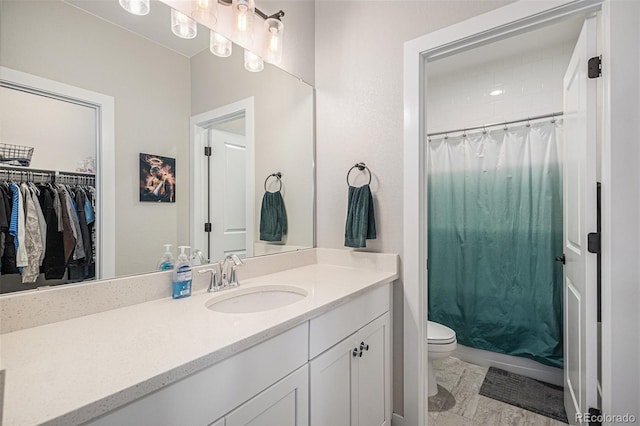 9380 Bear River St, Littleton, CO 80125 - bathroom with toilet, vanity, a shower with shower curtain, and a spacious closet