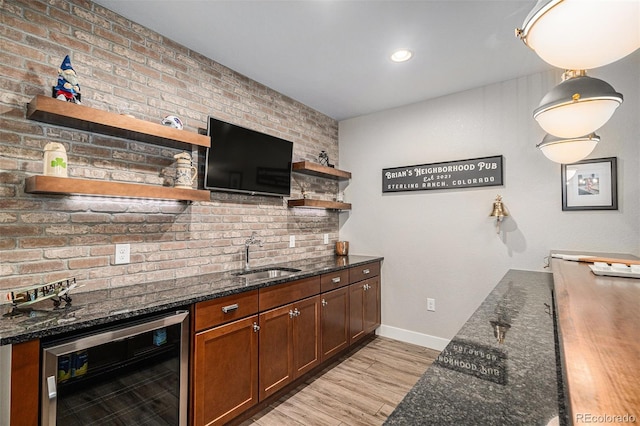 9380 Bear River St, Littleton, CO 80125 - indoor wet bar featuring beverage cooler, light wood-style floors, baseboards, recessed lighting, and pendant lighting