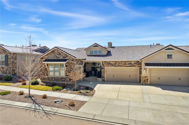 view of front of property featuring stone siding, a garage, concrete driveway, stucco siding, and a chimney