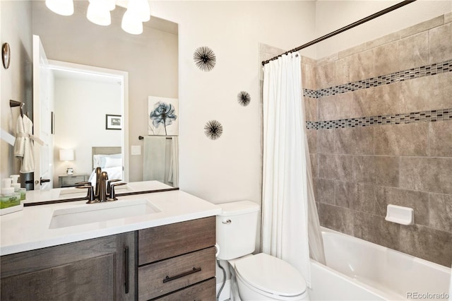 full bath featuring toilet, vanity, shower / tub combo, and ensuite bathroom