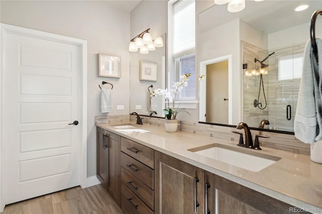 full bath with a shower stall and double vanity