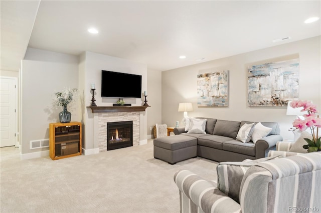 living area featuring carpet floors, recessed lighting, a stone fireplace, and baseboards