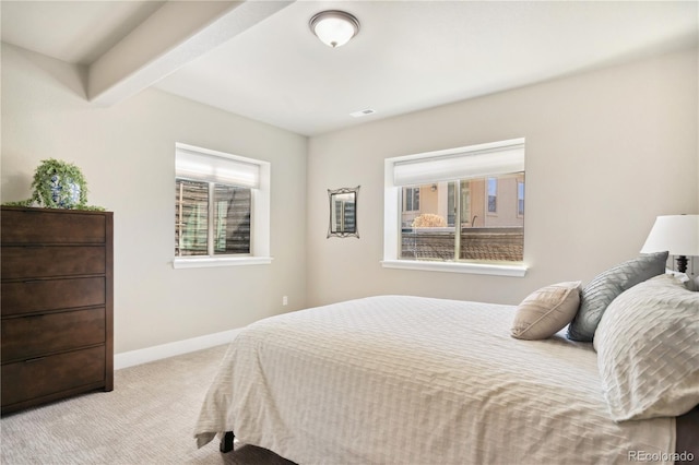 bedroom featuring carpet flooring, baseboards, and beamed ceiling